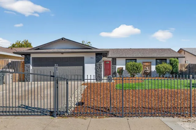 a front view of a house with a garden