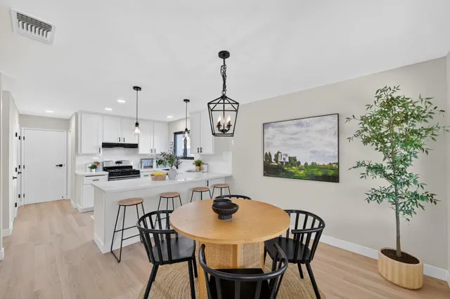 a view of a dining room with furniture window and wooden floor