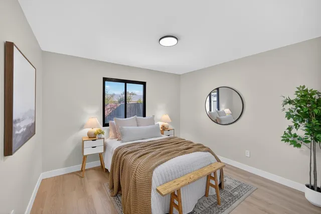 a bedroom with a bed and a potted plant