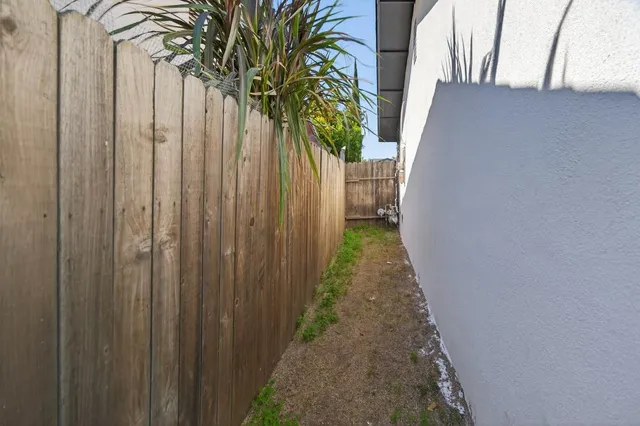 a view of a backyard with table and chairs under an umbrella