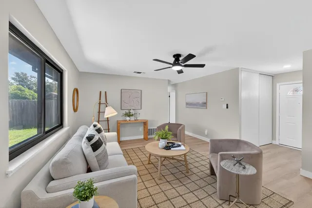 a living room with furniture and a large window