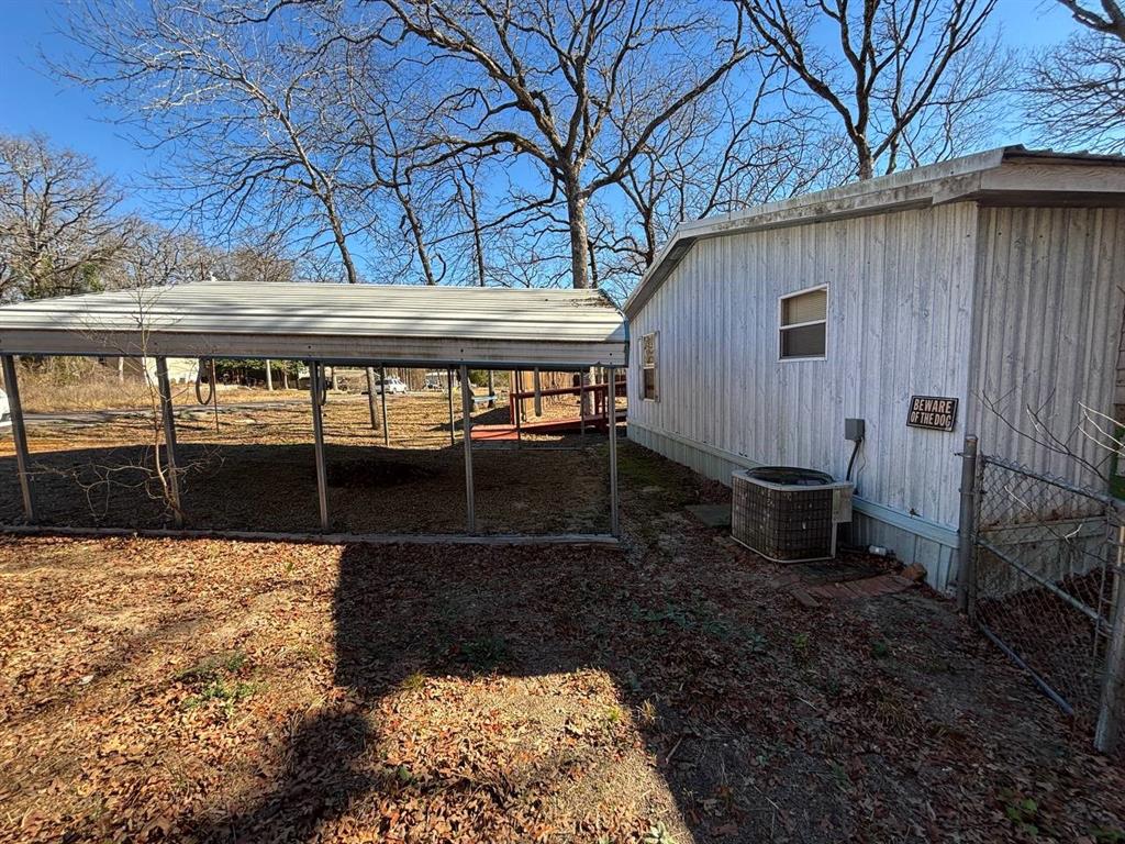 361 Cumberland Circle Murchison, TX 75778 - Photo 1 of 40 a view of a backyard with wooden fence and large trees