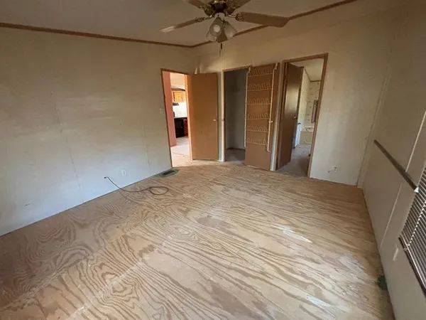 a view of a room with a chandelier fan and entryway