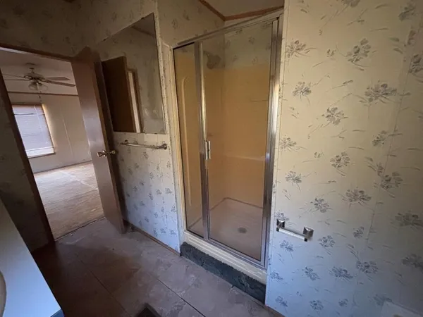 a bathroom with a glass shower door