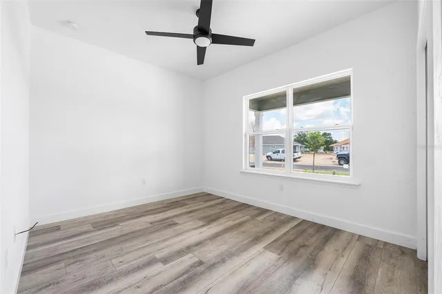 a view of a livingroom with wooden floor and window