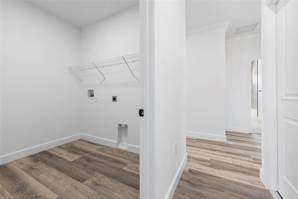 6723 Southwest 15 Place Gainesville, FL 32607 - Photo 14 of 24 a view of a room with wooden floor and white walls