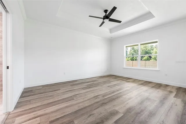 a view of empty room with ceiling fan