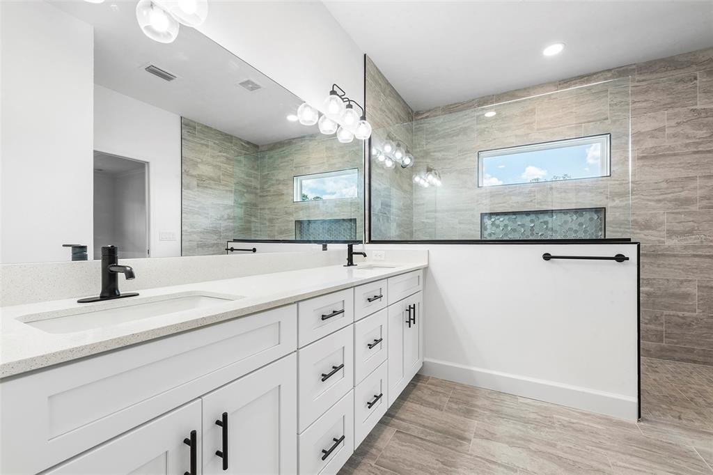 6723 Southwest 15 Place Gainesville, FL 32607 - Photo 21 of 24 a bathroom with a double vanity sink and a mirror