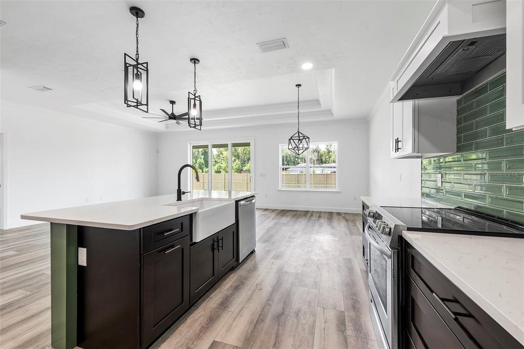 6723 Southwest 15 Place Gainesville, FL 32607 - Photo 8 of 24 a kitchen with a stove and a wooden floor