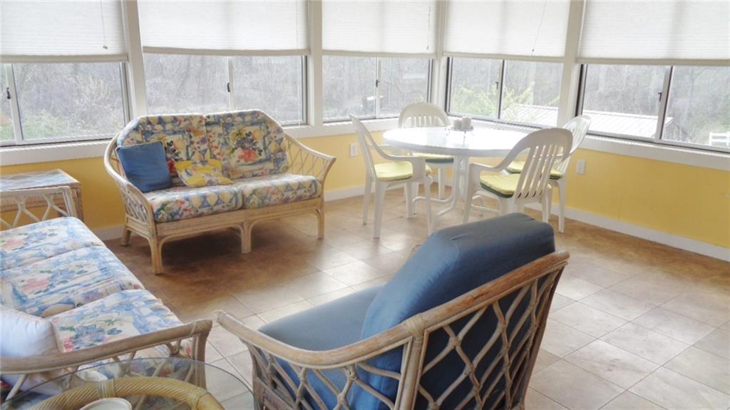 5081 West Harbison Road Pittsburgh, PA 15276 - Photo 8 of 24 SUN ROOM, OVERLOOKING BACK YARD AND WOODS, WITH STEPS LEADING TO BACK YARD. ALLOWS FOR ENJOYMENT OF THREE SEASONS.