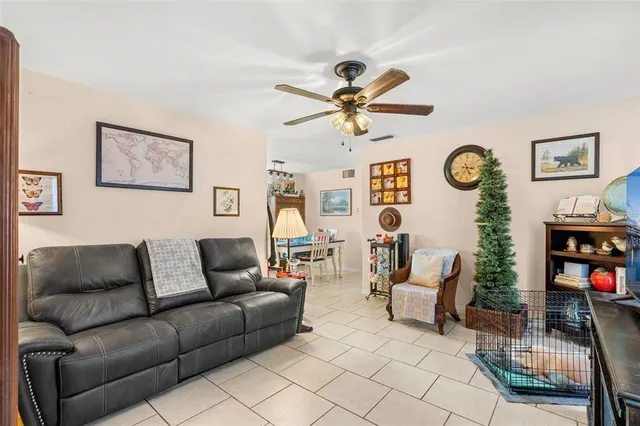 a living room with furniture a clock and a window