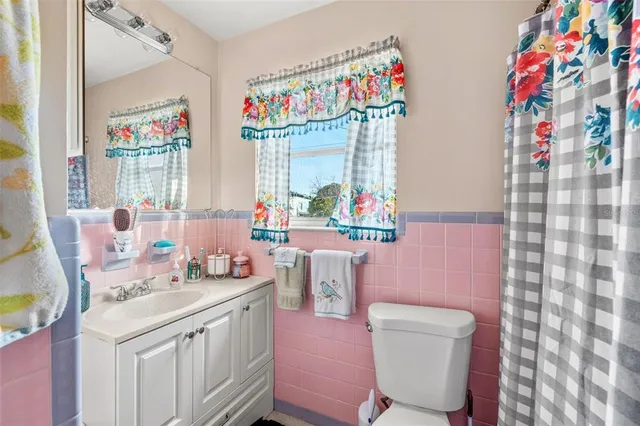a bathroom with a sink mirror vanity and toilet