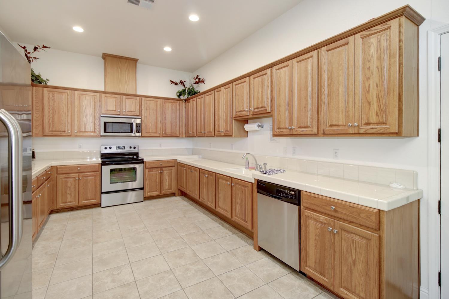 159 Emerald Lane Jackson, CA 95642 - Photo 6 of 64 Expansive kitchen featuring abundant wood cabinetry, light-toned countertops, and tile flooring. Located in the recreation center