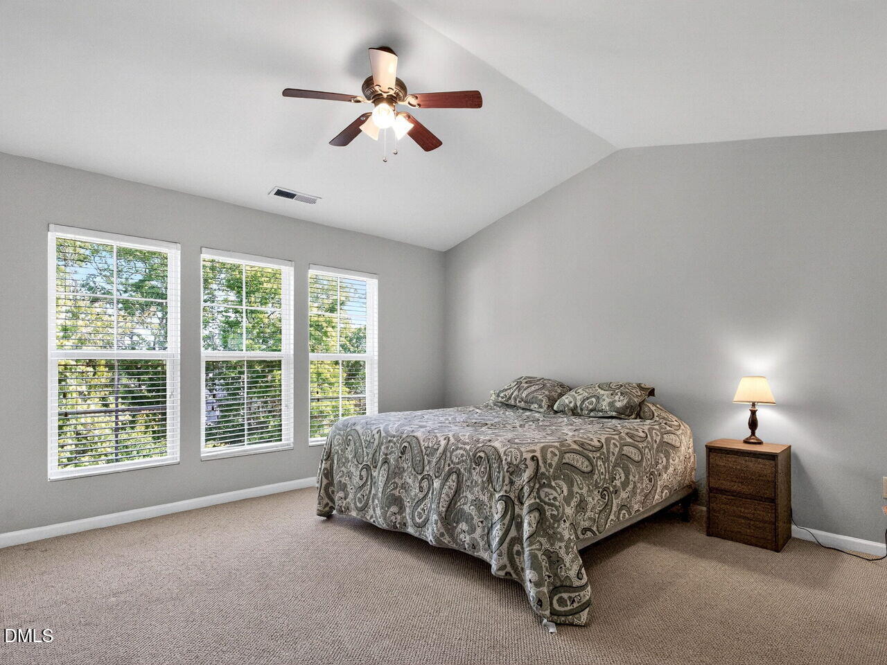 8215 Yaxley Hall Drive Raleigh, NC 27616 - Photo 19 of 42 a bed sitting in a spacious bedroom next to a window