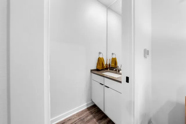 a kitchen with stainless steel appliances a sink a stove and a wooden floors