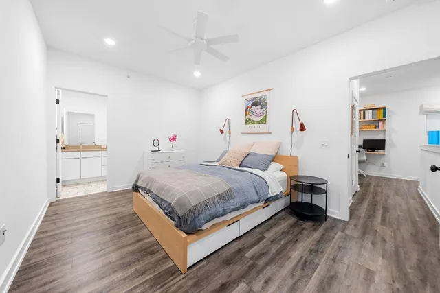 a bedroom with a bed and wooden floor