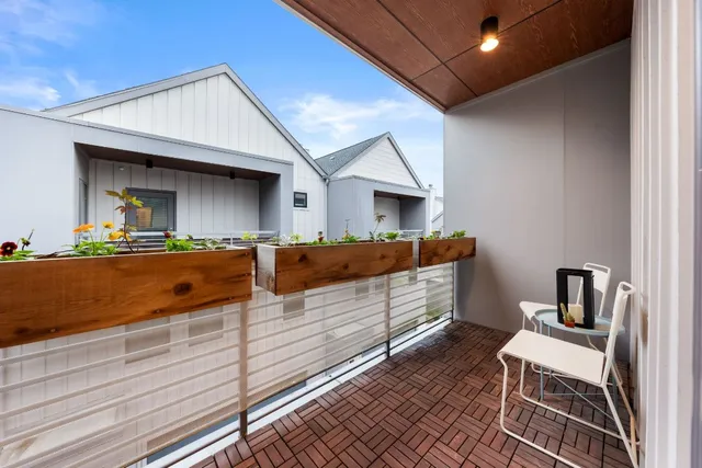 a bedroom with a bed and a view of kitchen
