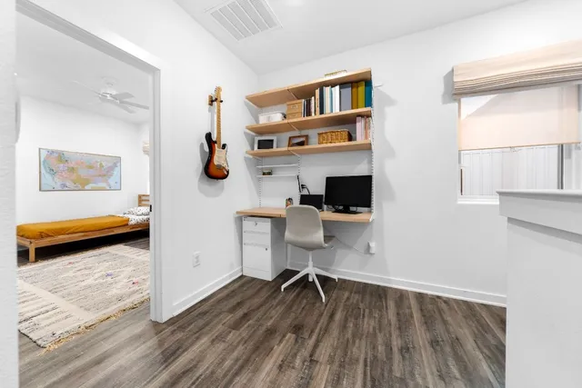 a utility room with dryer washer and a view of bedroom