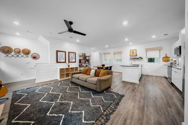 a living room with furniture and kitchen view