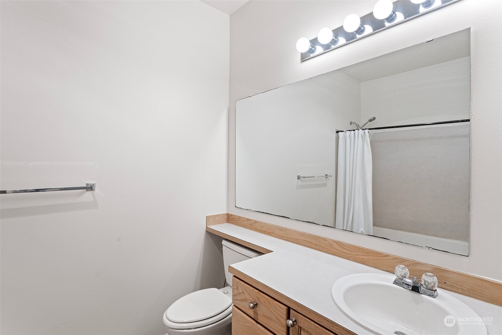 18930 Bothell Everett Highway, Unit V104 Bothell, WA 98012 - Photo 17 of 21 a bathroom with a sink a toilet and shower