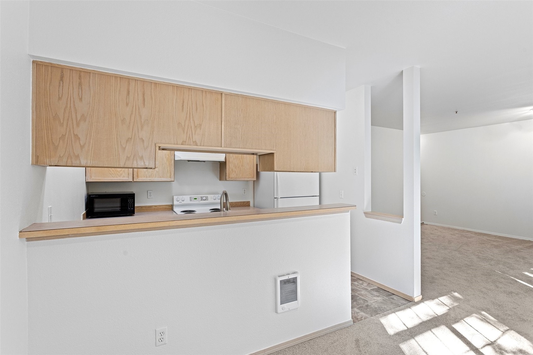 18930 Bothell Everett Highway, Unit V104 Bothell, WA 98012 - Photo 7 of 21 a kitchen with a sink a stove and cabinets