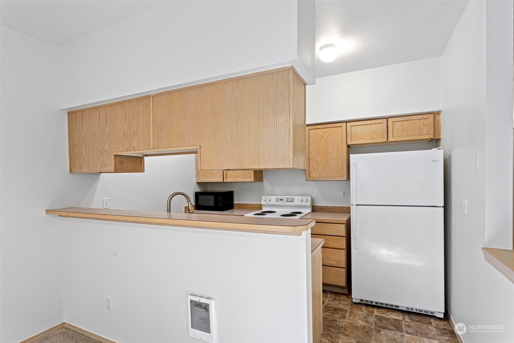 18930 Bothell Everett Highway, Unit V104 Bothell, WA 98012 - Photo 9 of 21 a white refrigerator freezer sitting inside of a kitchen