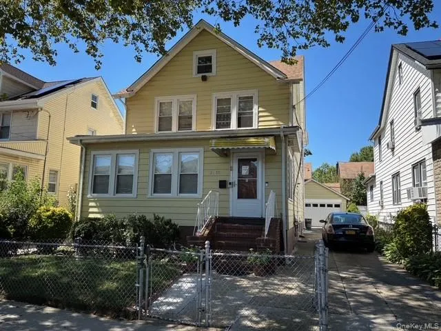 a view of a big house with a yard and plants