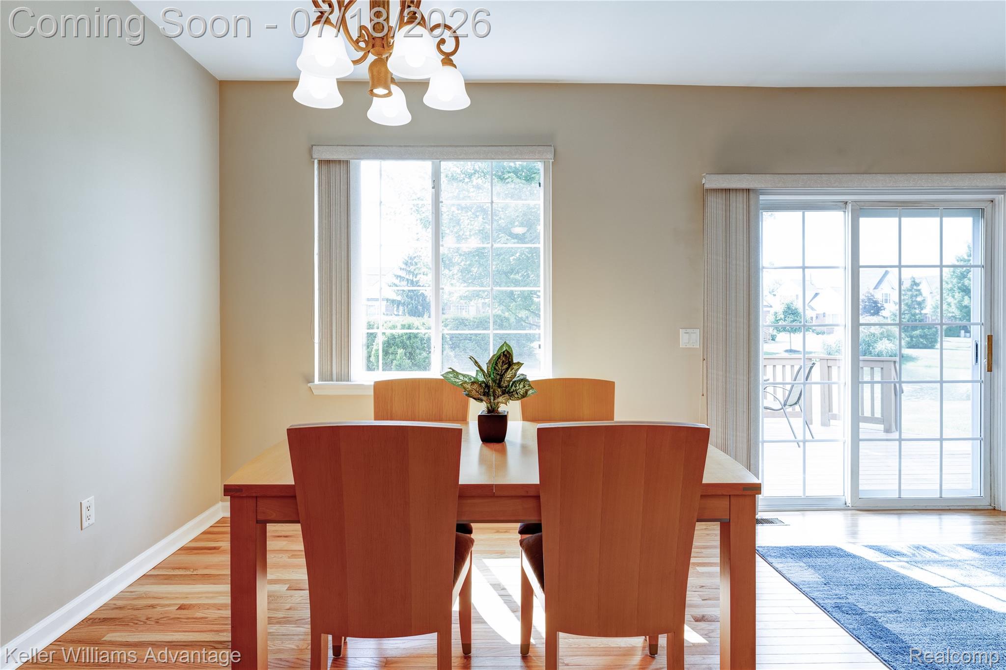 41647 Mitchell Road Novi, MI 48377 - Photo 22 of 43 Dining area featuring wood-finish flooring, a multi-pane window, and sliding glass doors opening to an exterior deck
