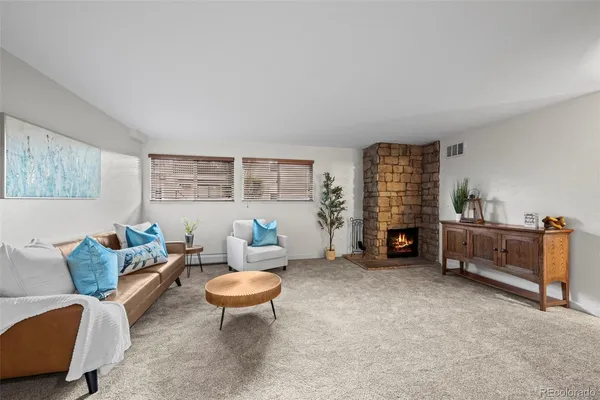 a living room with furniture a window and a table
