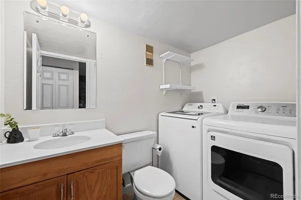a bathroom with a sink toilet and a mirror