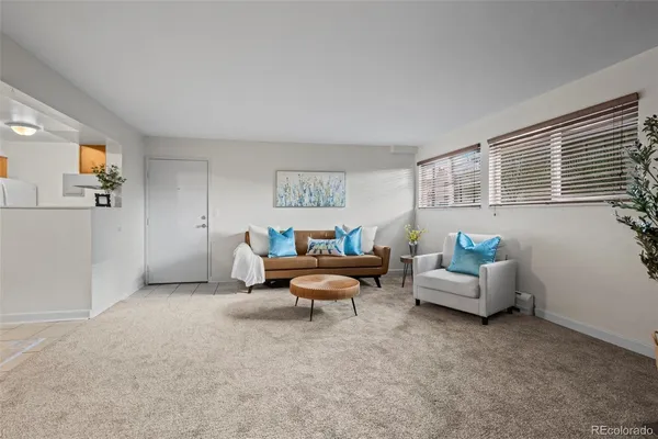 a living room with furniture and white walls