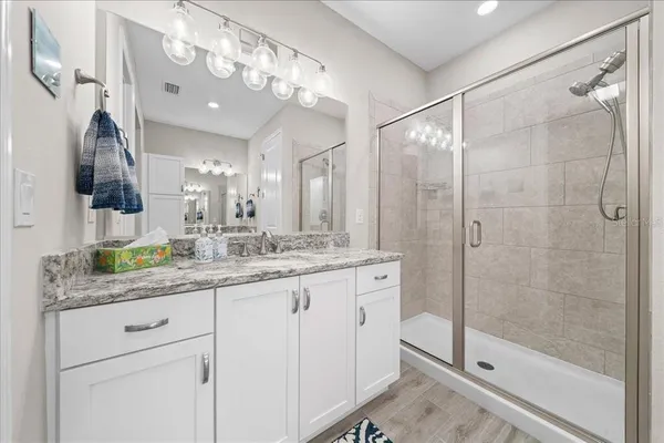 a bathroom with a granite countertop sink mirror and double