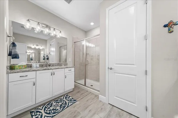 a bathroom with a double vanity sink and a mirror
