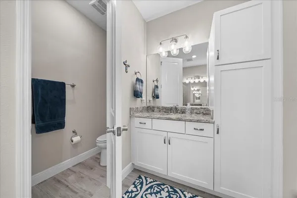 a bathroom with a granite countertop sink and a mirror