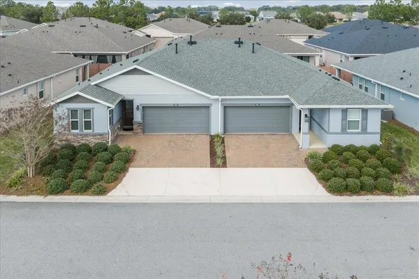 an aerial view of a house with a yard