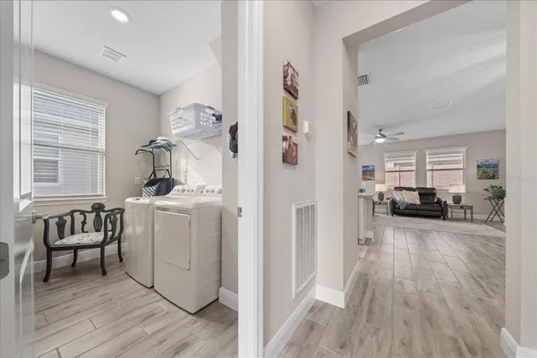 an aerial view of a city with lots of residential buildings and mountain view in back