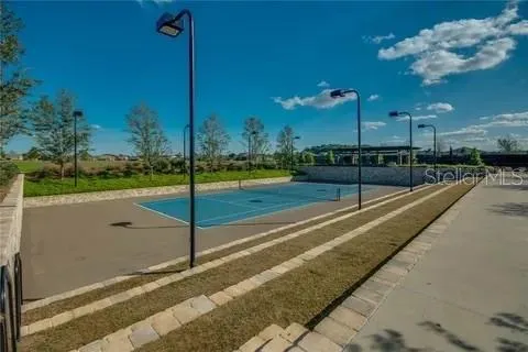 a view of a swimming pool with a yard and sitting area