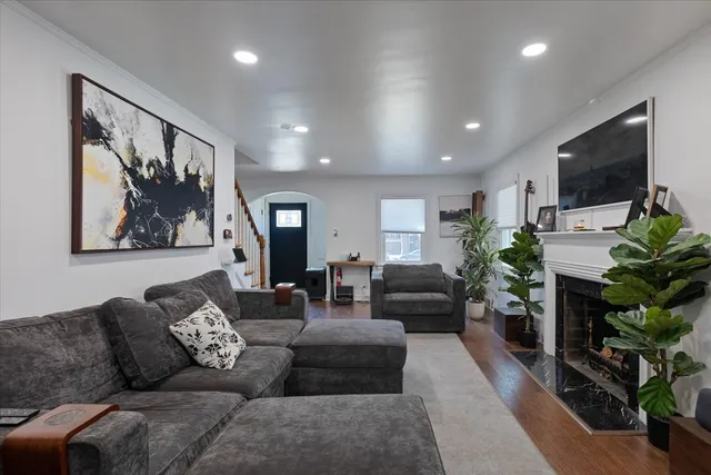 a living room with furniture a flat screen tv and a fireplace