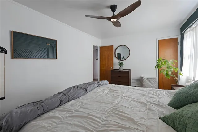 a bedroom with a bed and a large mirror
