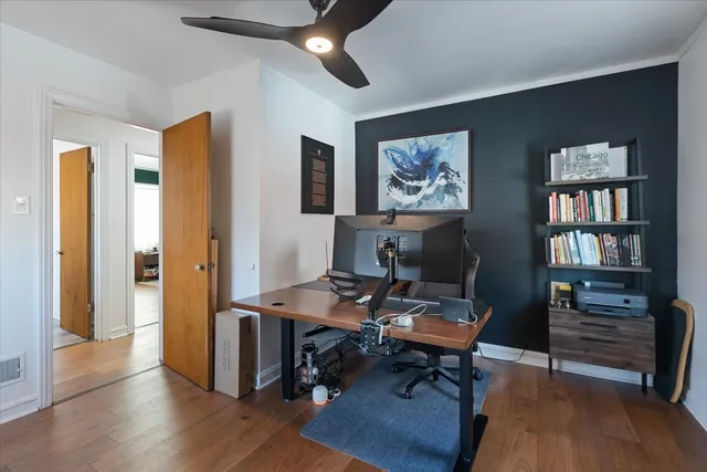 a view of a workspace with furniture and wooden floor