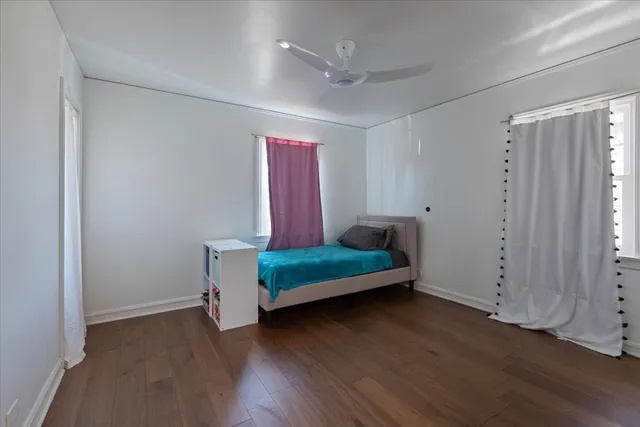 a view of a room with wooden floor and windows