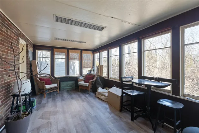 a living room with furniture and floor to ceiling windows
