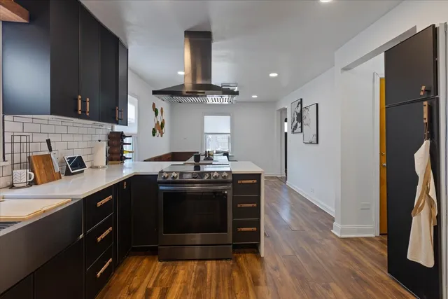a kitchen with stainless steel appliances granite countertop a stove and a refrigerator