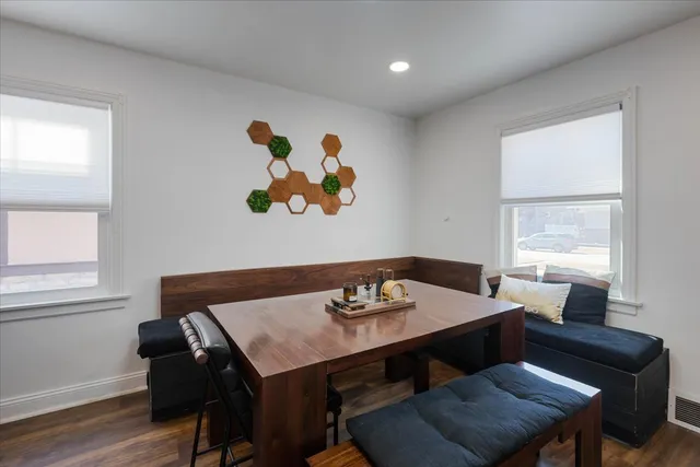 a view of a dining room with furniture and wooden floor