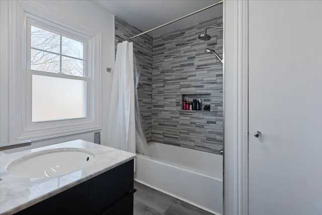 a bathroom with a bathtub and a shower
