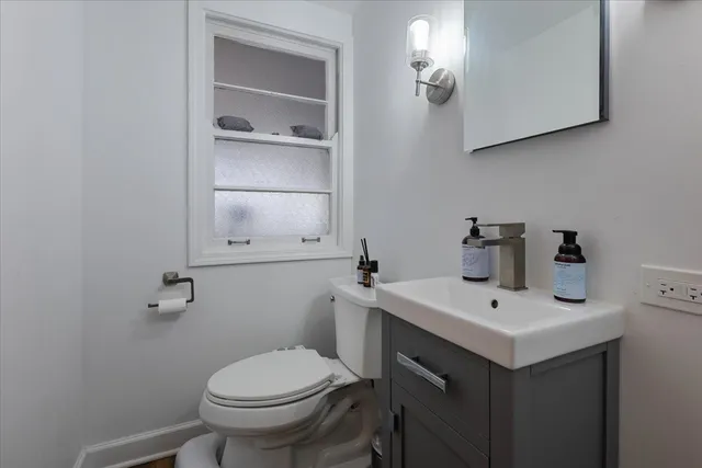 a bathroom with a sink toilet and vanity