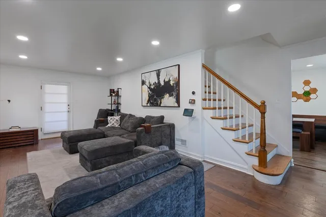 a living room with furniture and stairs