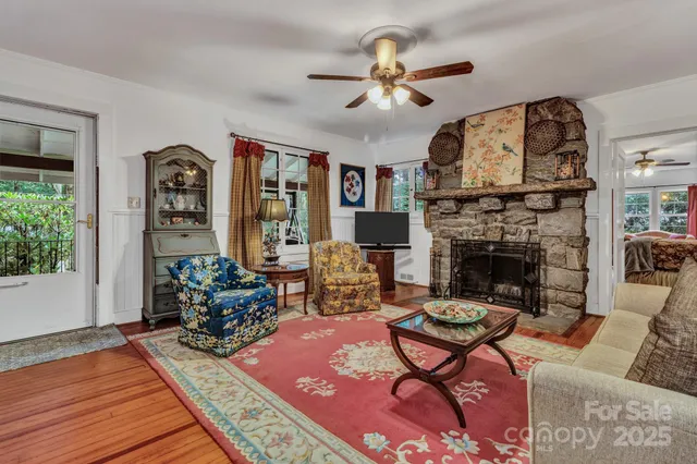 a living room with furniture fireplace and window