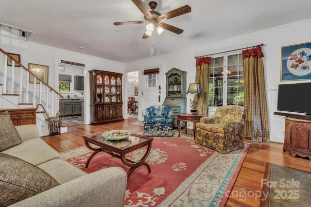 a living room with furniture a rug and a flat screen tv