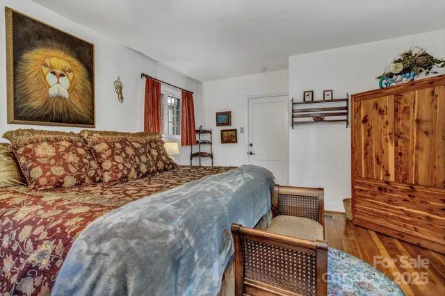 a bed room with a bed and a painting on the wall